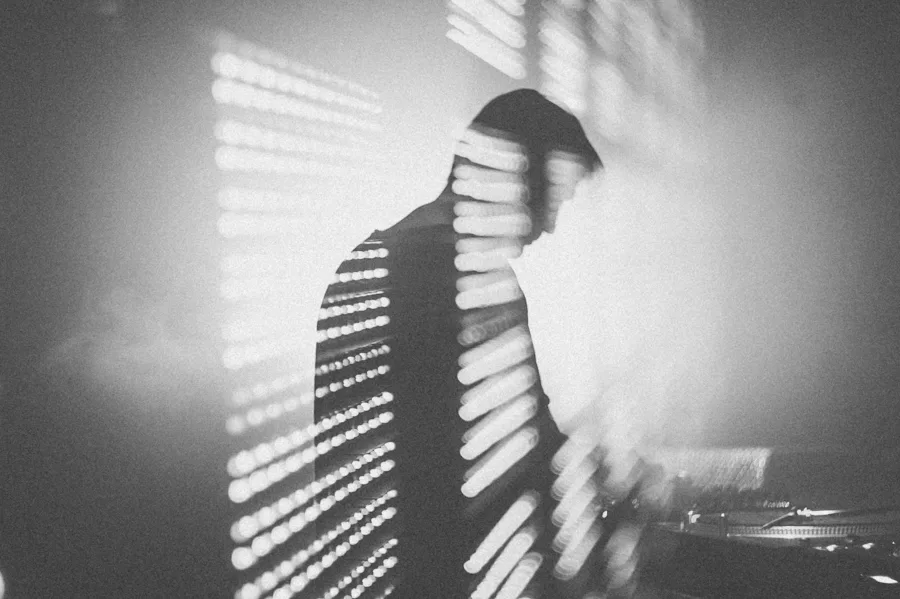 Gorbani at the decks in front of a light wall